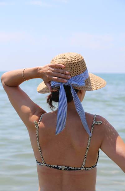 istock woman with straw hat at the sea 1014286514