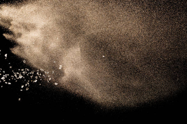 istock Golden sand with stone explosion isolated on black background. Abstract sand cloud. 1014287844