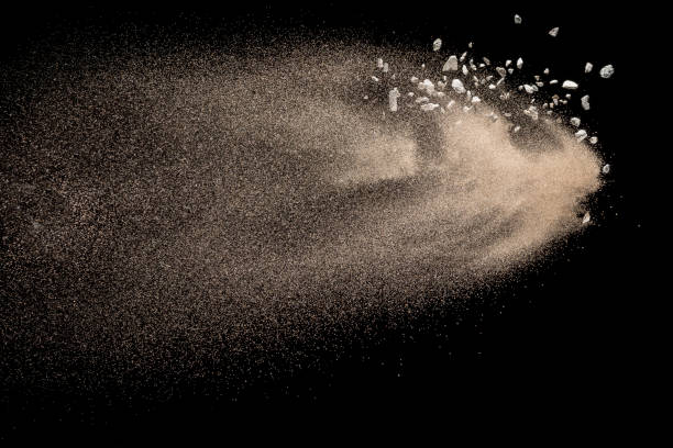istock Golden sand with stone explosion isolated on black background. Abstract sand cloud. 1014287870
