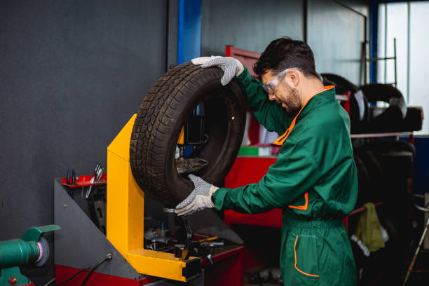 istock Mechanic removes car tire Machine for removing rubber from 1014291202