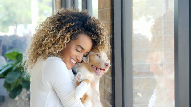 istock Woman hugs her adorable pup 1014291694