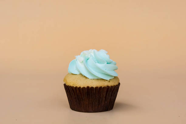 istock sweet cup cake dessert on yellow background and copy space 1014291764