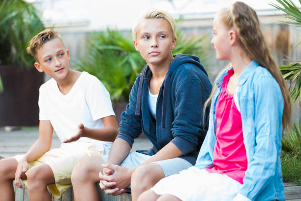 istock Happy kids having conversation outdoors 1014297570