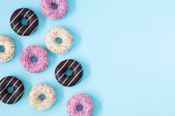 istock Flat lay donuts pattern on a pastel blue background with copy space for slogan. 1014298866