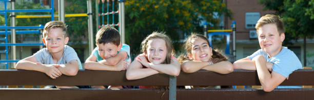 istock Glad children sitting on a bench 1014308870