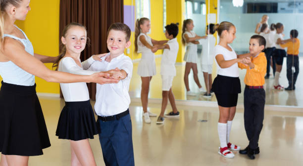 istock Little boys and girls having dancing class in classroom 1014311930