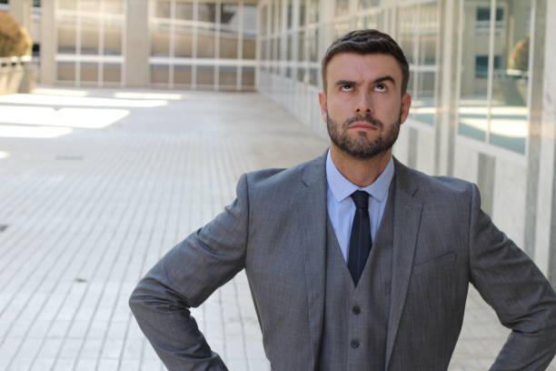 istock Fed up businessman rolling his eyes 1014312226