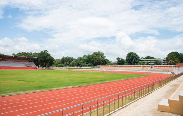 istock Green grass outdoor track with blue sky. 1014316814