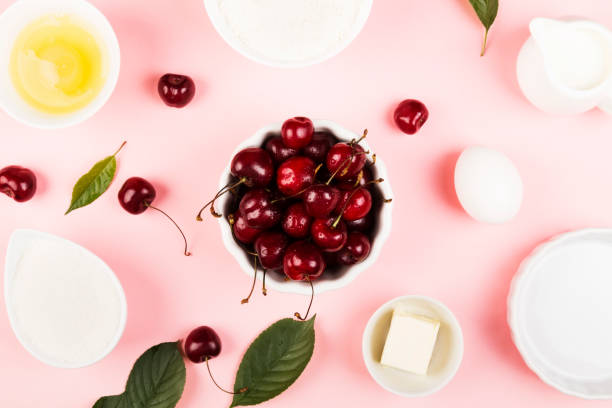 istock Ingredients for cherry pie - milk, butter, eggs, flour, cherry, sugar on a pink background. Top view. Food background 1014321520