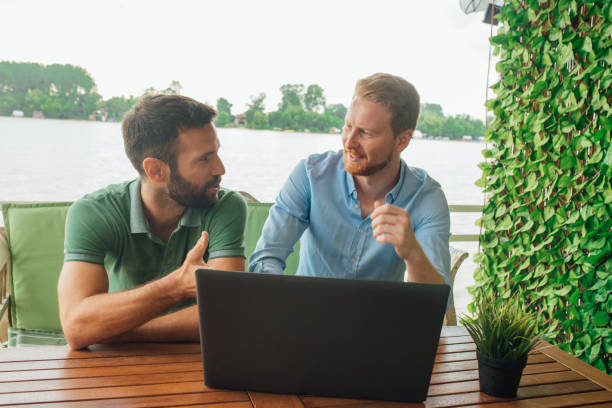 istock Men talking and pointing at laptop on the table 1014322504