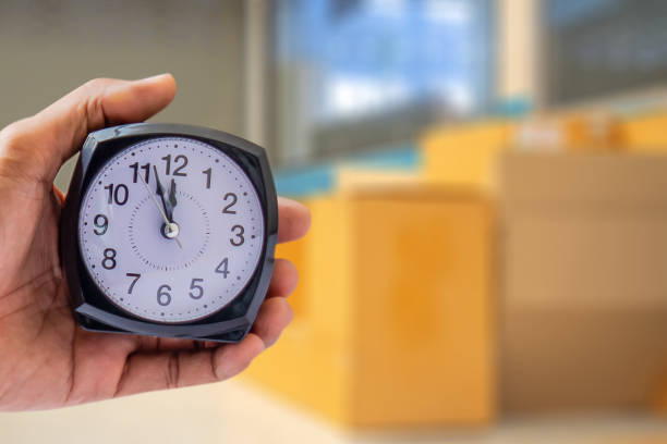 istock Holding clock on box industry blurred background The time 8:00 am or pm and noon or midnight for made clock isolated or White background Copy space move to clipping path 1014327374