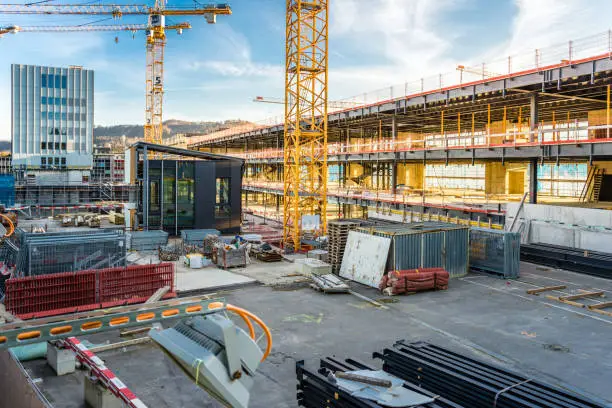 Photo of Large construction site in the evening with crane and scaffolding