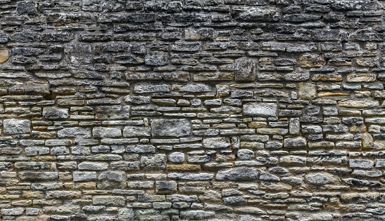 Old Stone Wall Background. Uneven Chaotic Stone Texture.