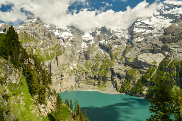 istock Amazing Oeschinensee lake surrounded by steep peaks 1014334126
