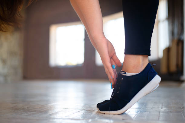 istock Woman hands stretching to toecaps, close up 1014346710