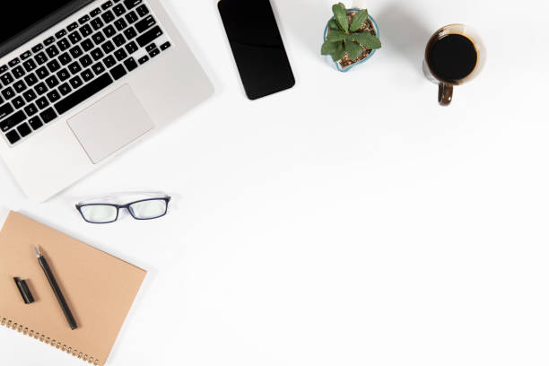 istock Office table with laptop computer, smartphone, pen, notebook and coffee on isolated pure white background / Laptop and tablet mockup concept. (Selective Focus) 1014357272