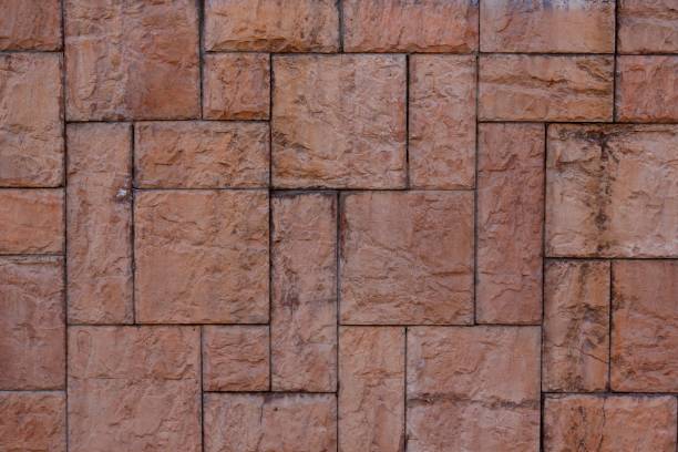 istock Textured wall tiles under the stone structure. Stone wall use as background. 1014375080
