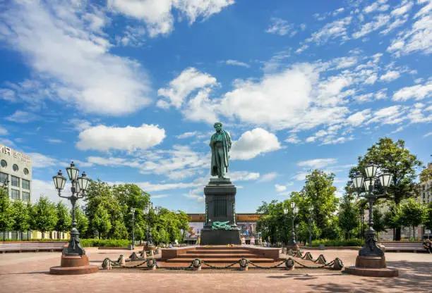 Monument to Pushkin on Pushkin Square in Moscow and lanterns on a summer sunny morning under a blue sky with clouds