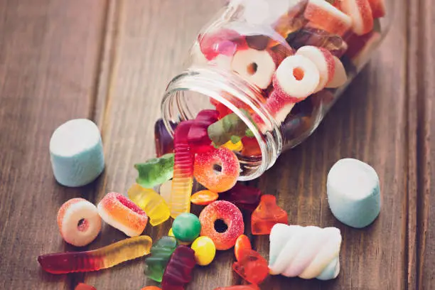 Photo of Various sugary candy in a glass jar