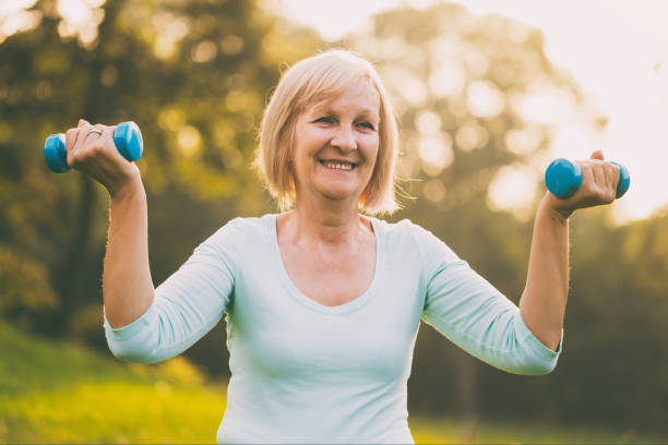 istock Senior woman exercise with weights 1014389304