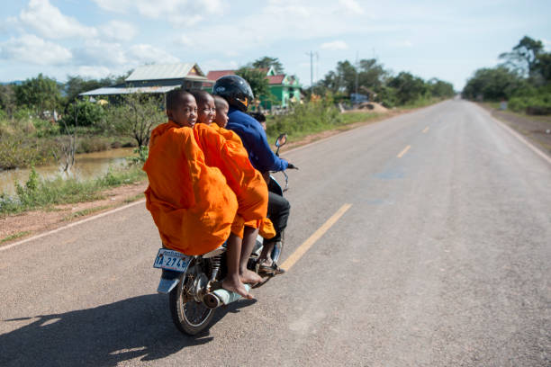 a motorbike on a road near the town of Sra Em in the province of Preah Vihear in Northwest Cambodia.  Cambodia, Sra Em, November, 2017,