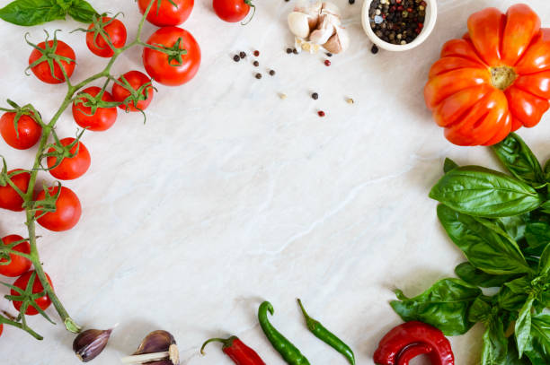 istock Cherry tomato branch, garlic, fresh basil, pepper on a light background. Ingredients for making sauces. Italian Cuisine. Free space for your project. 1014404360
