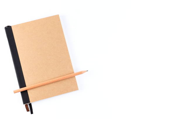istock Top view cover note book with cream with pencil placed on white background, space for letter type. Isolated , Copy space. 1014413800