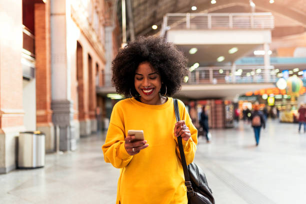 istock Beautiful woman using mobile in the train station 1014414478