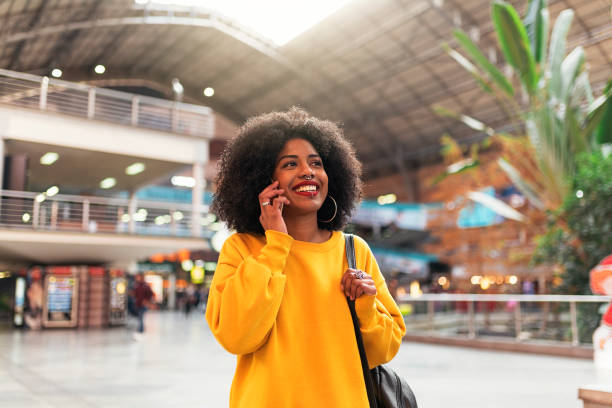 istock Beautiful afro woman using mobile in the train station. 1014414500