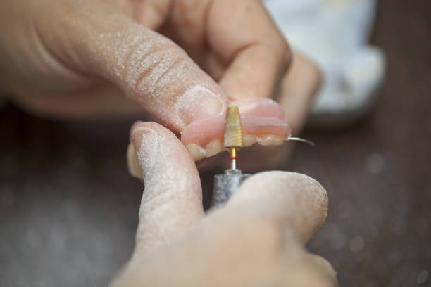 istock Dental technician make denture prothesis in dental laboratory 1014418770