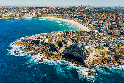 Aerial view of Bondi Beach with the Sydney CBD in the background.