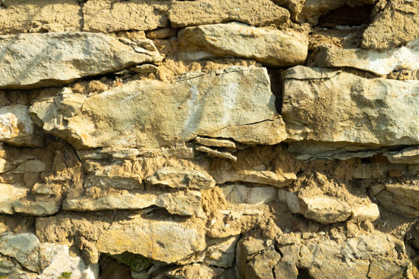 istock Background texture, stone buds, limestone, basalt, cobblestone, granite, pebbles, slate, sandstone laid the wall or in the fence close up for inscriptions or advertisements. 1014424876