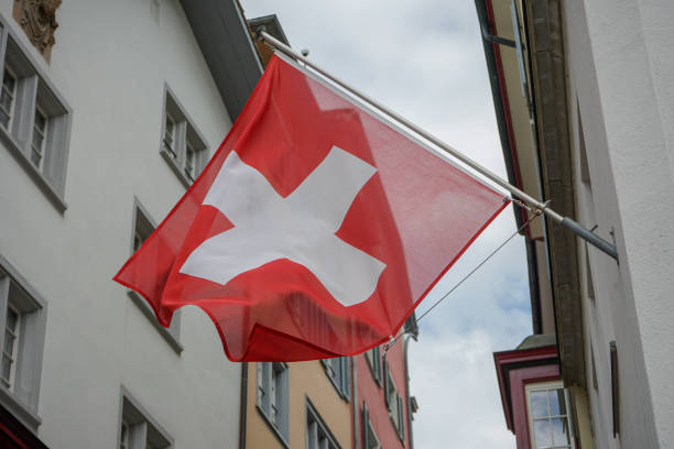 istock Swiss Flag hanging from Building Facade 1014432322