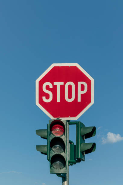 istock red traffic sign and stop sign under blue sky 1014432444