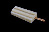 Frozen white fruity yogurt on stick with missing bite, isolated on black