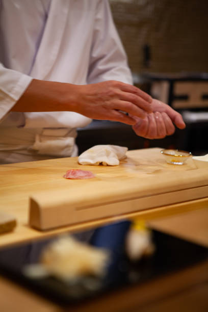 istock Professional sushi chef carefully using just the right pressure to make perfect sushi with confident and dedication. 1014436210