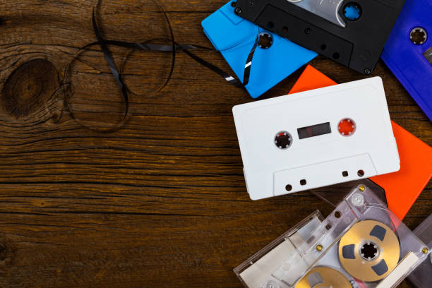istock Compact Audio Cassette Tape on Wooden Background with Copy Space 1014436456
