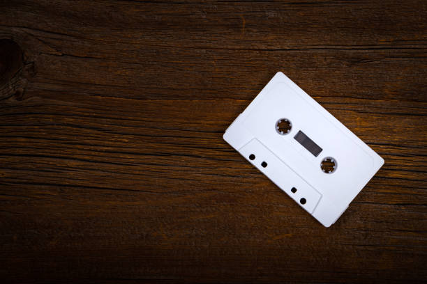 istock Compact Audio Cassette Tape on Wooden Background with Copy Space 1014436546