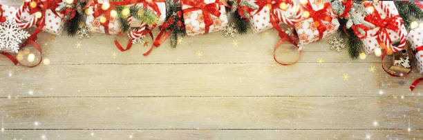 istock Gift boxes and Christmas ornaments on wood background, border design, top view 1014450856