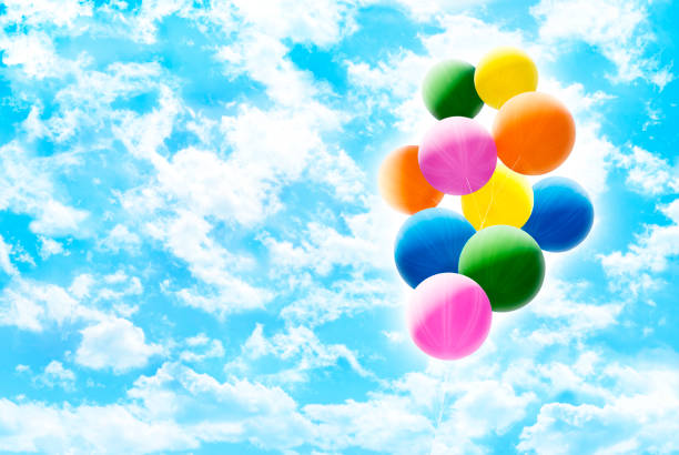 istock Colorful Balloons over Sunny Cloudy Sky 1014458860