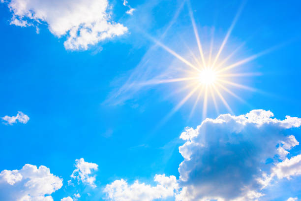 istock Sunny background, blue sky with white clouds and sun 1014458990