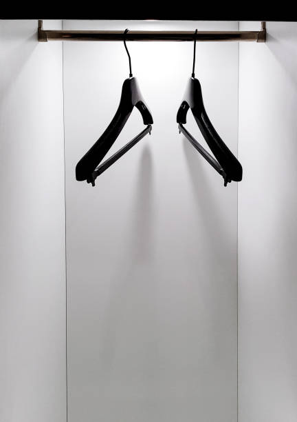 istock Black hangers with no clothes on them, in empty wardrobe 1014465820