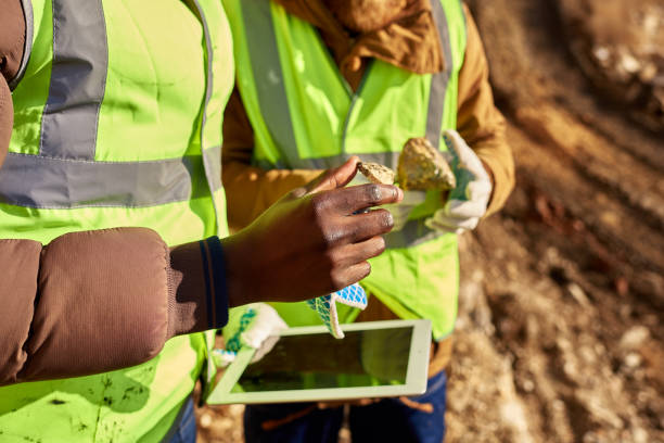 istock Miners Inspecting Worksite Searching for Minerals Closeup 1014465932