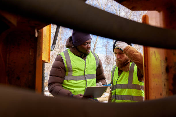 istock Two Miners Inspecting  Vehicle 1014465936