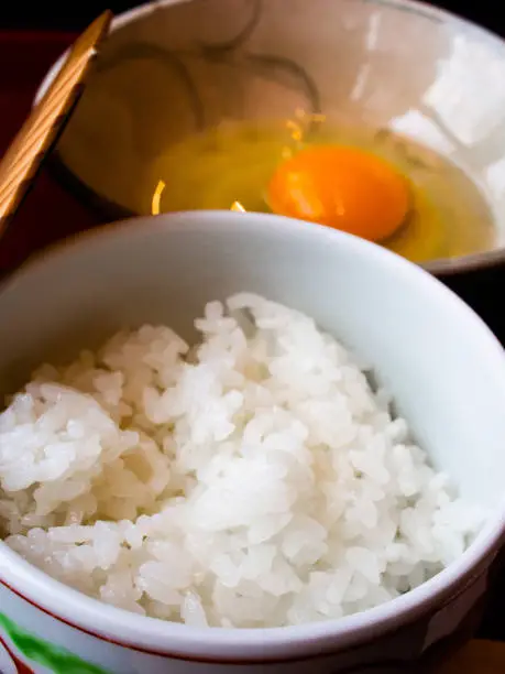 Photo of Hot and freshly cooked rice with whole raw organic egg from happy hen.