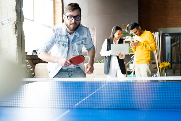 Man Playing Table Tennis in Office