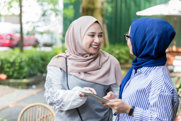 istock Female friends looking at digital tablet 1014480368