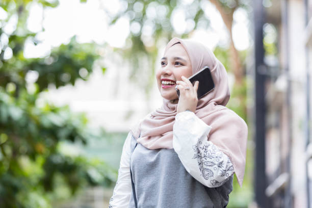 istock Beautiful Malaysian woman using smartphone 1014480388