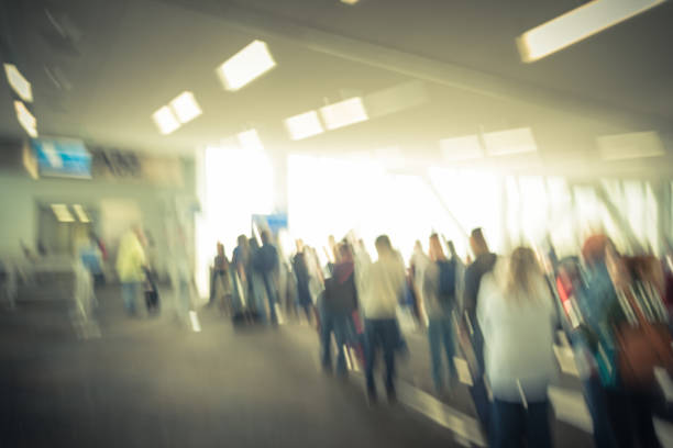 istock Motion blurred people waiting at terminal gate in American airport 1014486464