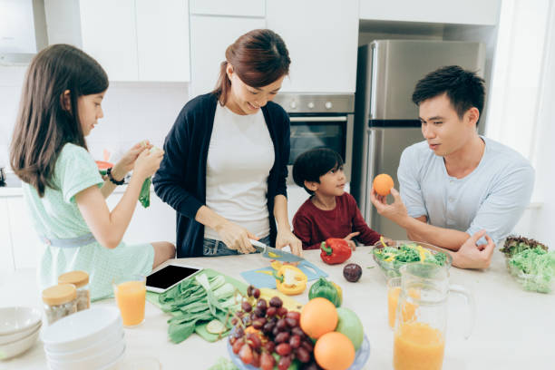 istock Cheerful family preparing lunch together 1014494094